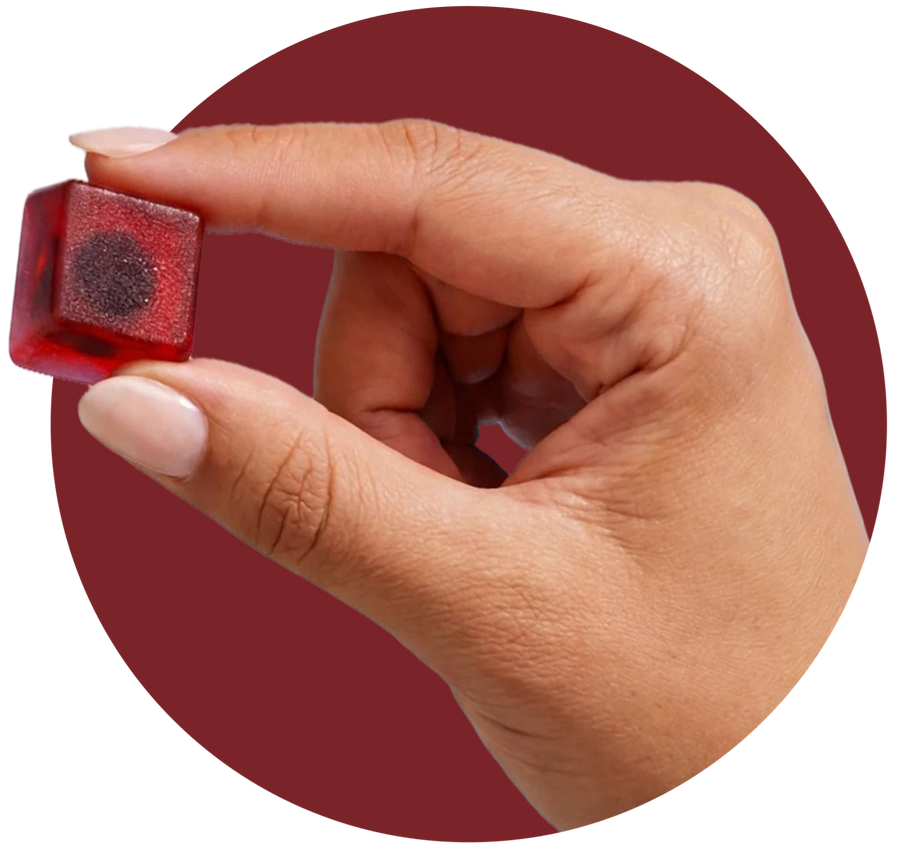 Hand holding a Renew NAD+ gummy