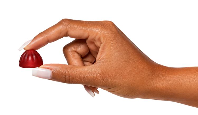 Holding a Goli Zero Sugar gummy